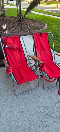 Two red beach chairs, used in good condition