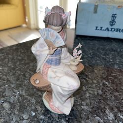 Retired Oriental Nippon Lady Lladro figurine # 5327 Piece Features an Asian Lady Sitting with a Bird and Hold