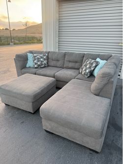 Grey sectional couch with ottoman