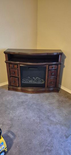Brown electric heater fireplace.