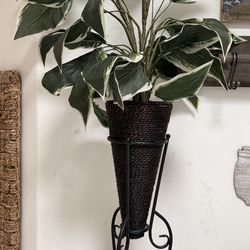 2 artificial plants in wicker baskets