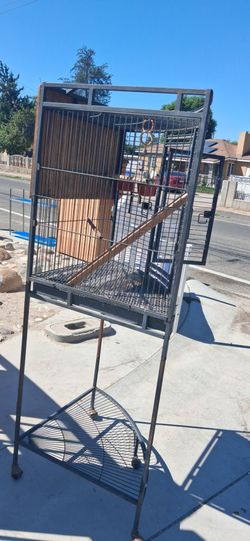 Solid metal bird cage.  Good condition.  69 inches tall.   28 inches bird area cage.