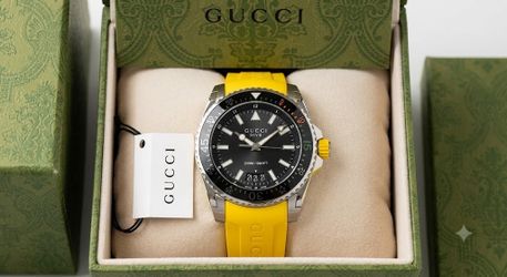 GUCCI Diver 136.3 Black Dial Yellow Rubber Strap Man’s Watch Ref. YA136319   New never worn comes with tags box and papers  This one retails over $1,2