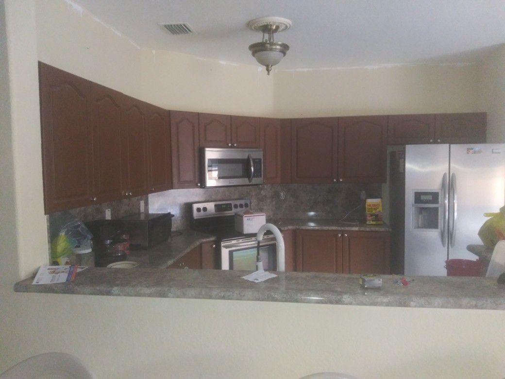 Kitchen cabinets and formica counter top and a double sink