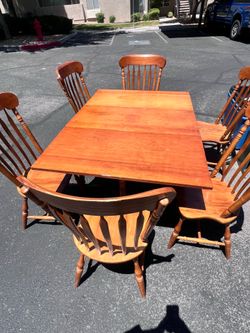 vintage-style wooden dining set with 6 spindle-back chairs and a drop-leaf/expandable table