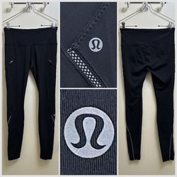 Lululemon Cadence Crusher leggings with zippered pockets and reflective detail size