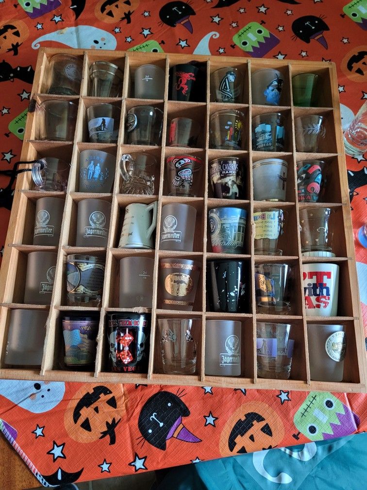 Collection Of Shot Glasses And Display Cabinet