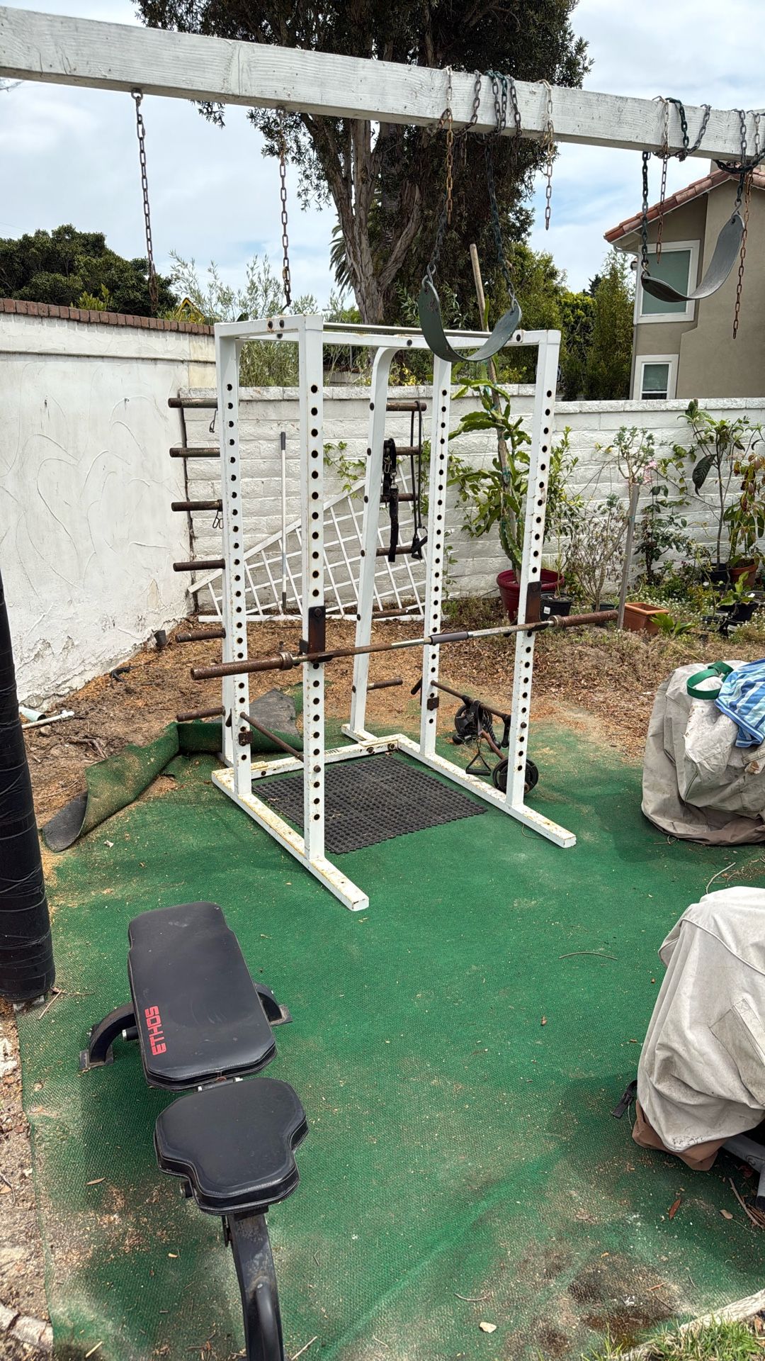 Half rack squat rack for weightlifting, including barbell with no weights.