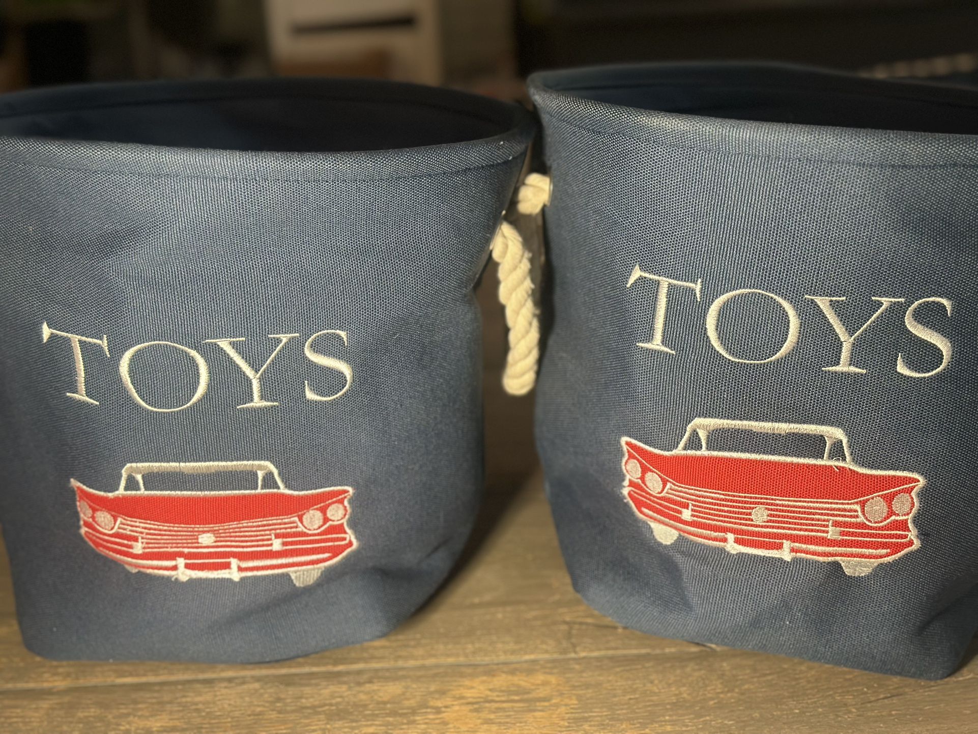 Gently used set of 2 blue toys storage basket with red classic car rope handles