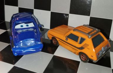 Rod "Torque" Redline, the dark blue American Muscle car, and Grim, the orange AMC Gremlin
