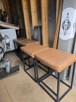 4 Bar Stools with Cushions. never used only for staging a couple times