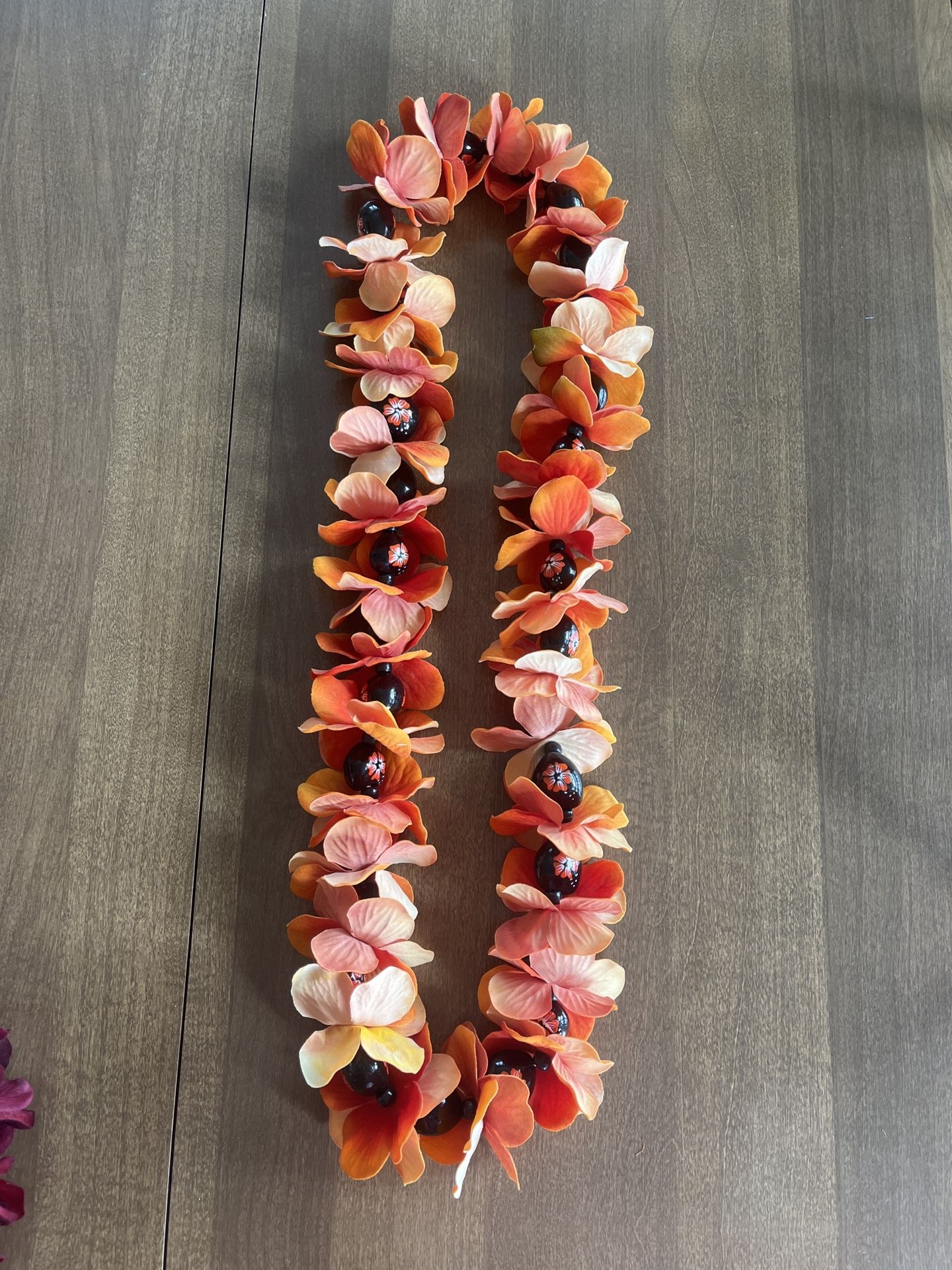 Orange Beaded Lei With Orange Flowers On Bead