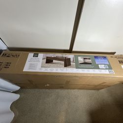 Very nice Whitlee Lift-Top Coffee Table in the box. Brown color. Open box.