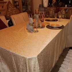 A glass dining room table six and a half foot long by three and a half foot wide,  with glass BASE
