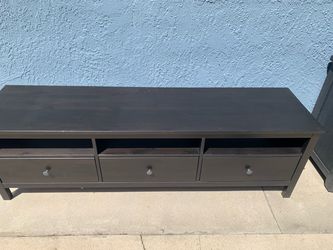 Dark wood TV stand with shelves and drawers