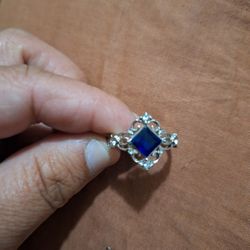 Dark Blue Stone With Little Diamonds Around It