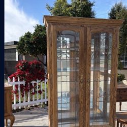 Tall oak curio cabinet