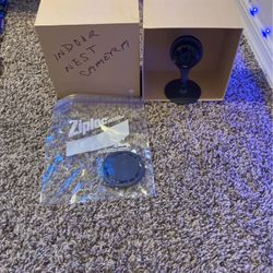 Black indoor Google nest camera with mounting bracket and cord