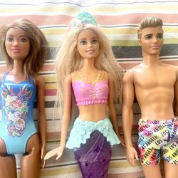 ** 4 Barbie and Ken Dolls **