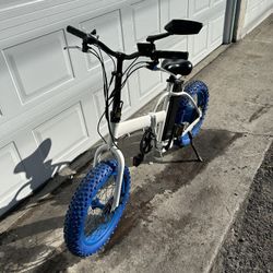 E-Bike. White With Blue Tires..