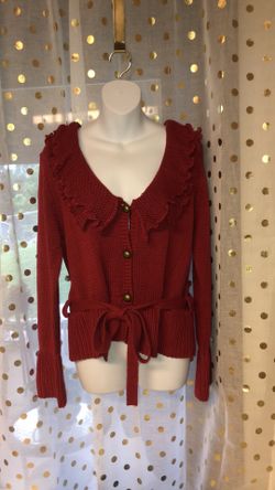 Size medium red ruffle top sweater that has a belt that can be taken off and worn without if wanted. Only tried this on. Never worn for more than 5 m