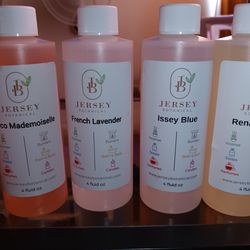 8 Brand New Unopened 4oz Bottles  Of Ladies Body Oils. 