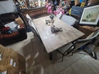 Brown with marble top dining room table and 4 chairs