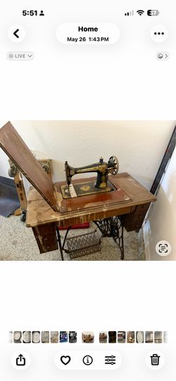 This is an antique Singer treadle sewing machine, specifically a Singer Model 27 or 127, recognizable by its distinctive gold "Sphinx" (also known as 