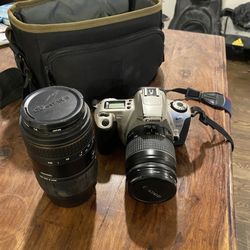 Vintage 35mm Canon Rebel Camera with telephoto lens