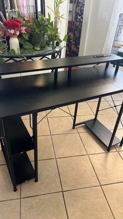 Black desk with outlets, used condition but other than that it has no problems