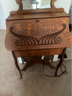 This item is an antique Art Nouveau quarter-sawn oak slant-front secretary desk