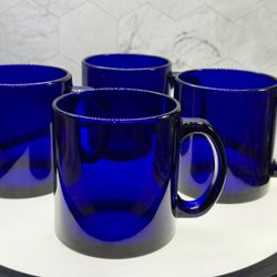 Set of (4) As-Is. Vintage Arcoroc cobalt blue glass mugs made in France.  Material: Durable tempered glass. Color: Rich, cobalt blue. Purpose: Commonl