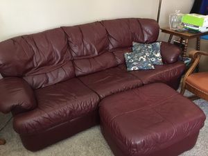 Photo Leather couch plus ottoman. Queen fold out bed. Asking $50 obo