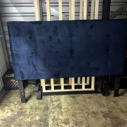 Blue upholstered bed, with a wooden frame