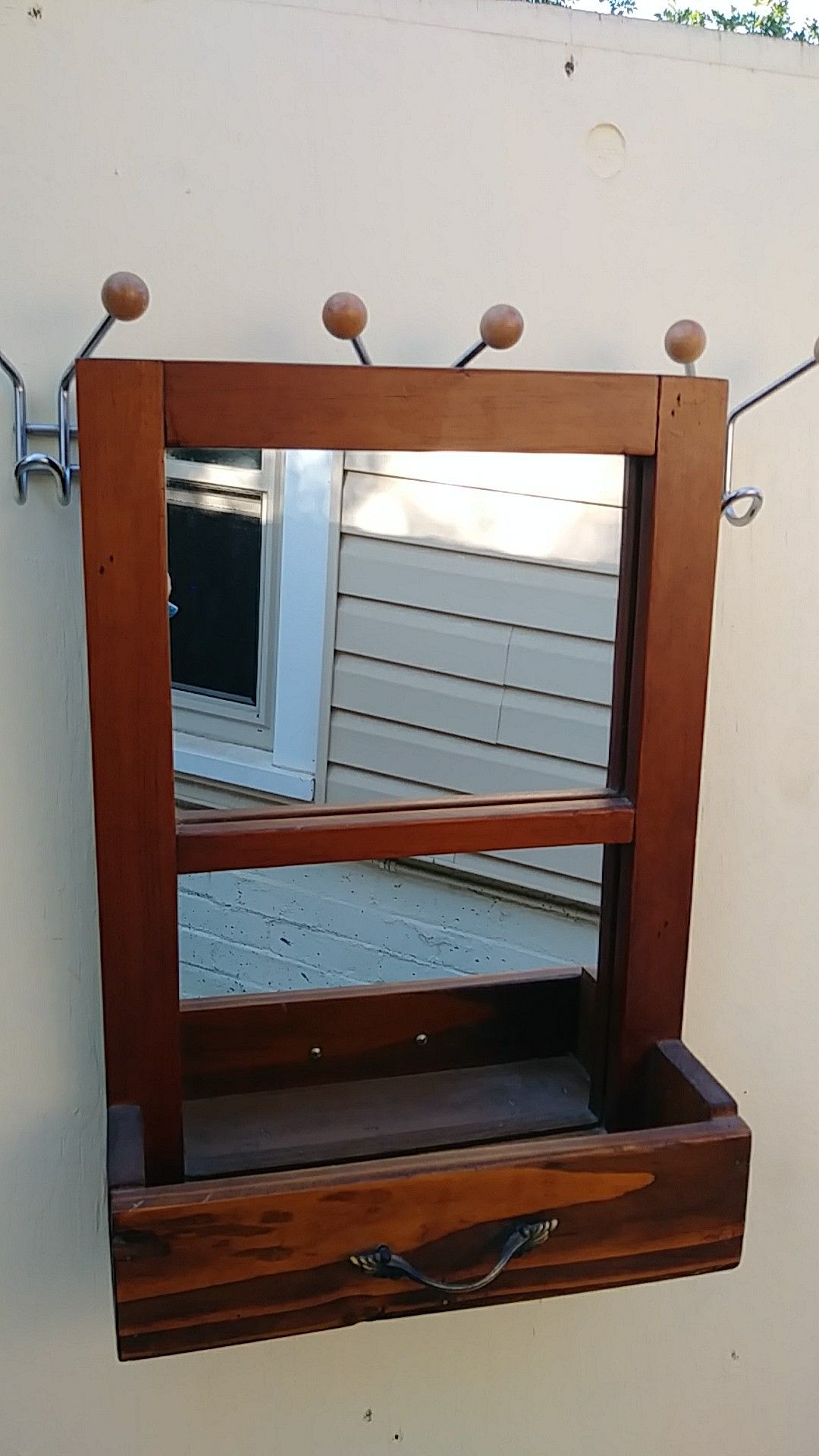 Solid oak antique mirror. It is NOT a coat hanger. Its just hanging on one to take the pic.