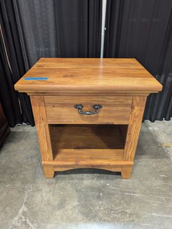 Brown Stained Wood Nightstand with Ornate Drawer Pull
