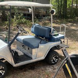 A very nice golf cart brand new batteries very nice paint job brand new rims and tires and a 4 inch lift kit a brand new battery charger and the four 