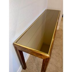 A Contemporary style sofa table by Henredon. Solid oak with a plank design mirrored top, brass banding around edge of top, slightly recessed inward ap