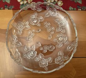 Mikasa Bella Rosa Hostess clear floral platter.  Made of clear glass with a raised, frosted rose design. The edges are scalloped or ruffled.