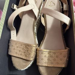 Pair of rose gold espadrille wedge sandals