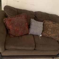 2 Sofa Pieces Both Have Pillows 