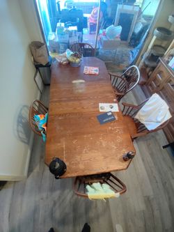 Large Solid Wood dining table with removable leafs and 6 chairs.
