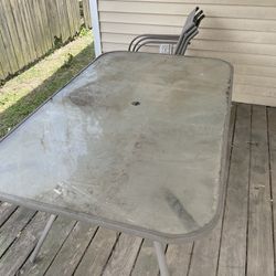 large glass top patio table and 6 chairs 