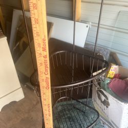 a neat metal rack 26 inches tall and 9 inches across