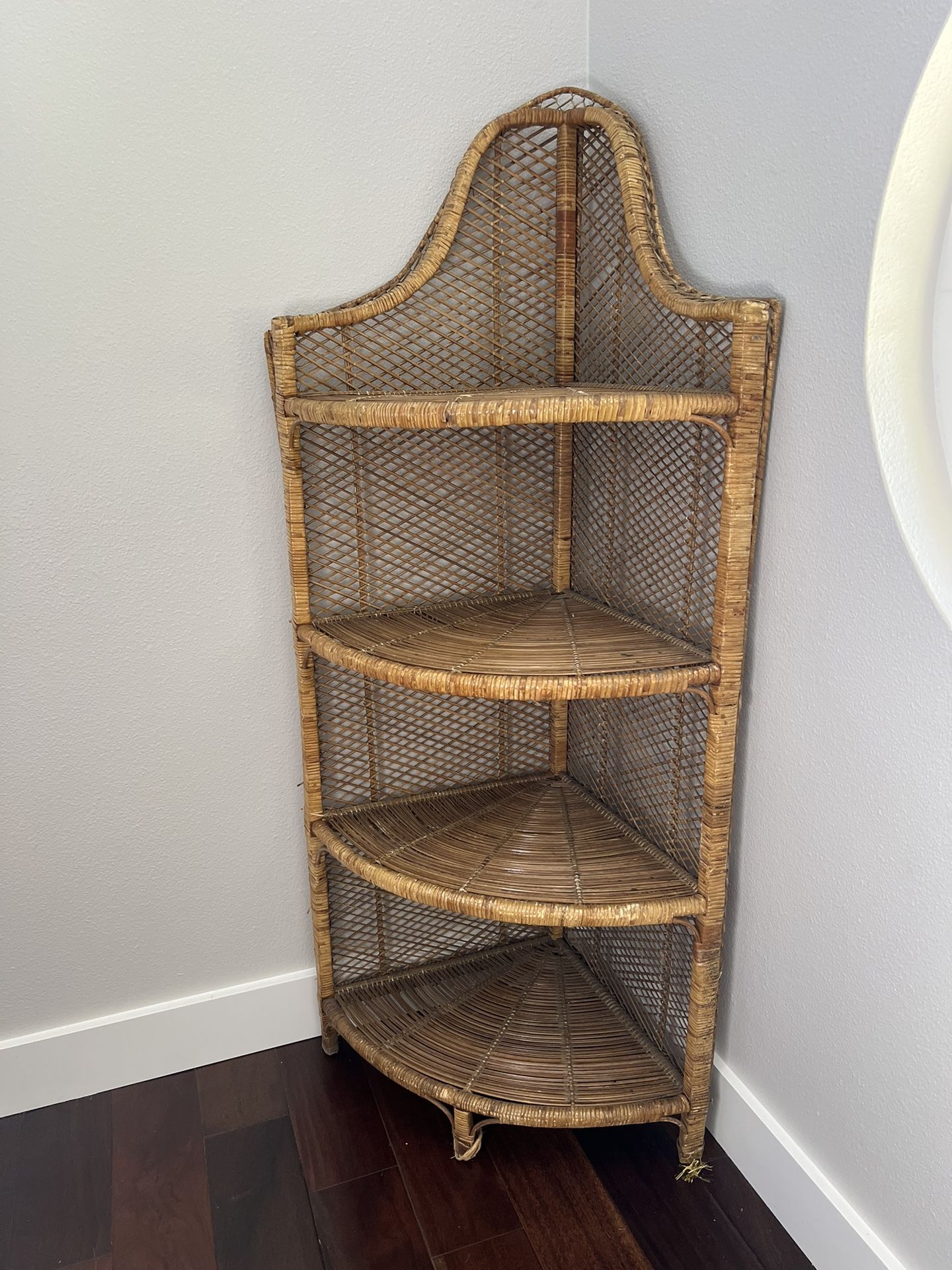 Tall corner wicker Rattan shelving unit.