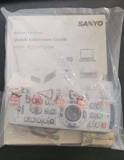 Sanyo PLC-WXU30A projector remote  control and guide book.