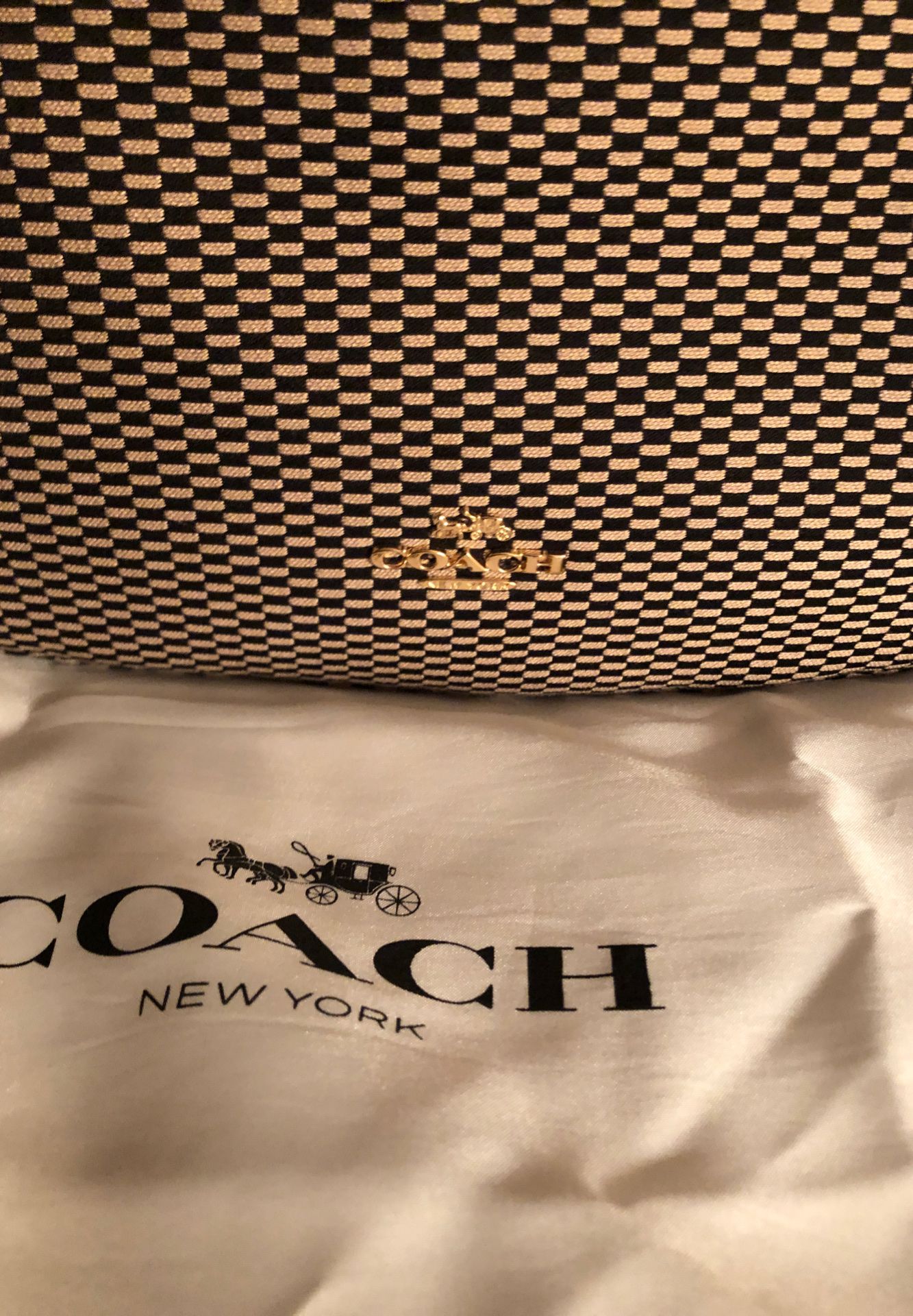 This Black and Beige Coach upper shoulder/ waist shoulder. Comes with dust bag. In good condition. Like new.