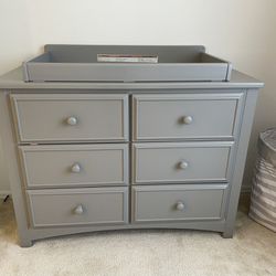 Nursery furniture set: Delta crib, dresser, changing table topper, and under the crib storage drawer