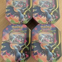 Selling 4 charizard x mini tins