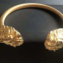 Statement gold color bracelet with lions design